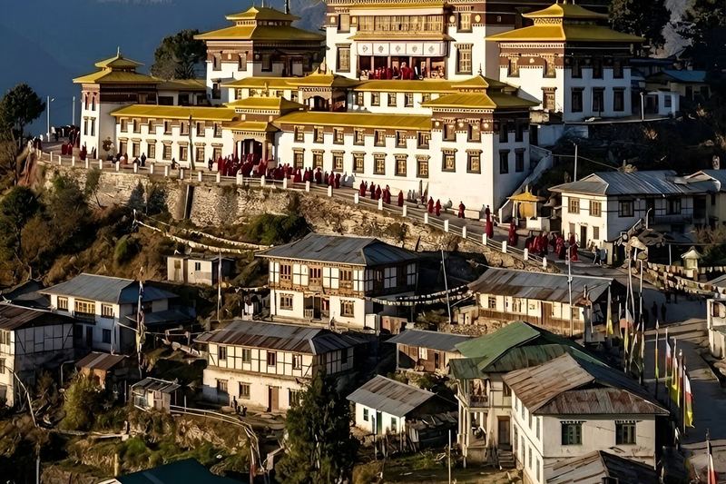 Tawang Monastery above the hillside town of Tawang, with monks gathered along its terrace